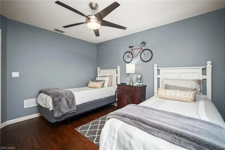 Bedroom with dark wood finished floors and ceiling fan