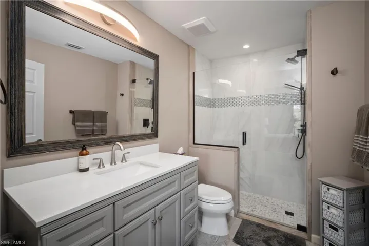 Bathroom featuring vanity and a shower stall