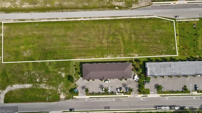 Aerial view of property and surrounding area featuring property parcel outlined
