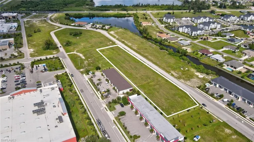 Aerial view of property and surrounding area featuring a nearby body of water