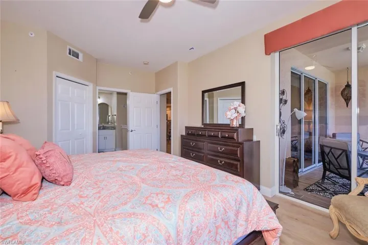 Bedroom featuring light hardwood / wood-style floors, ceiling fan, and access to outside