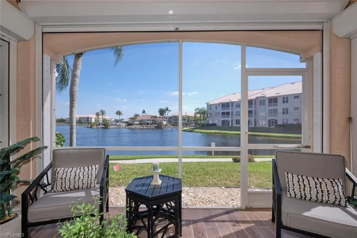 Sunroom / solarium with a water view and plenty of natural light