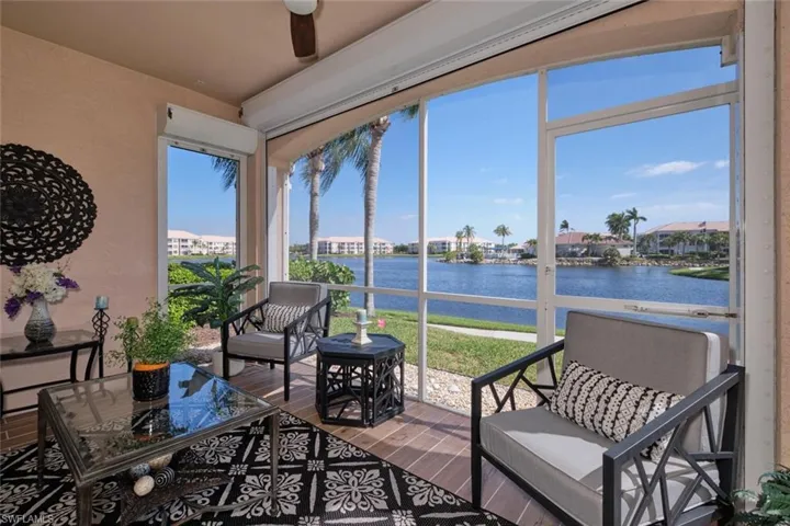 Sunroom featuring a healthy amount of sunlight, a water view, and ceiling fan
