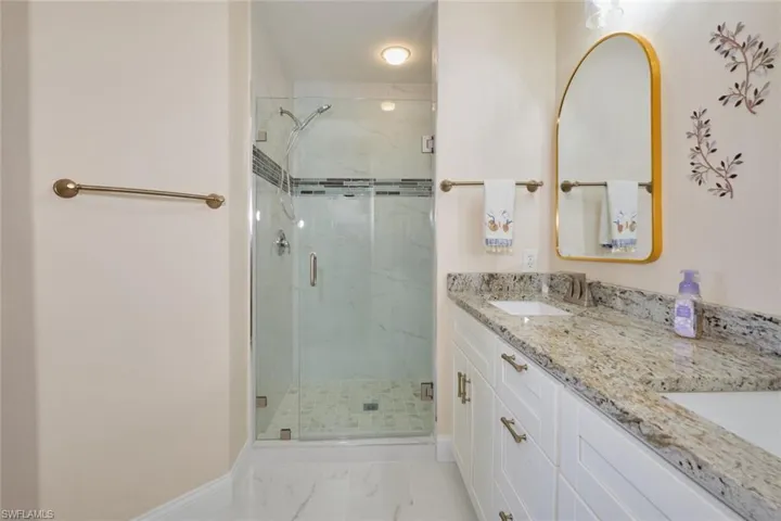 Bathroom featuring vanity and a shower with shower door