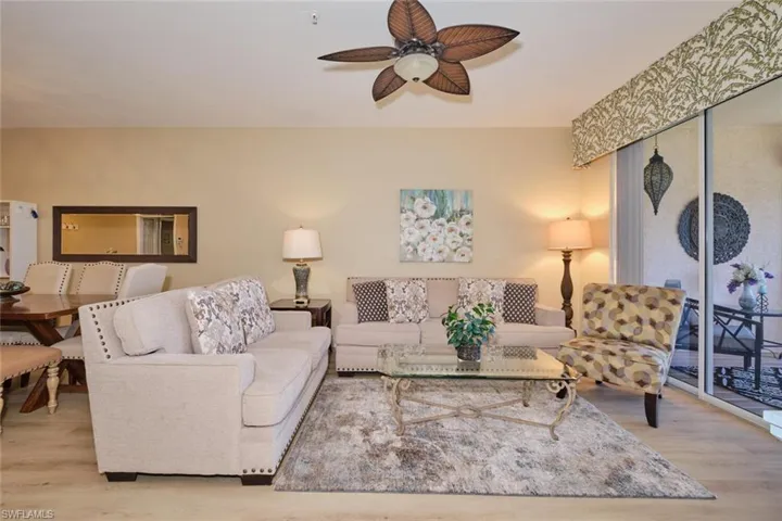 Living room featuring ceiling fan and light hardwood / wood-style floors