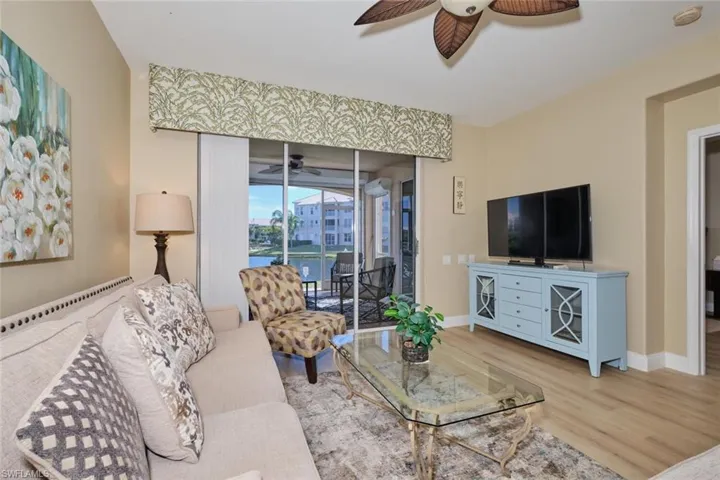 Living room with hardwood / wood-style flooring and ceiling fan