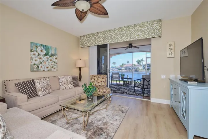 Living room with ceiling fan and light wood-type flooring