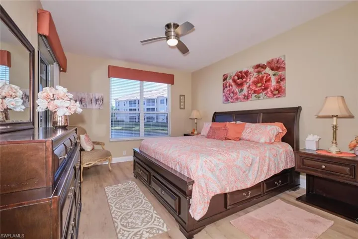 Bedroom with ceiling fan and light wood-type flooring