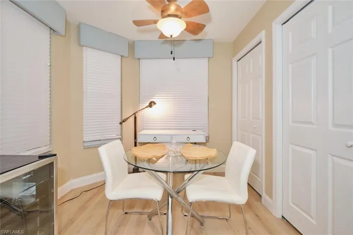 Dining room featuring ceiling fan, light wood-type flooring, and beverage cooler