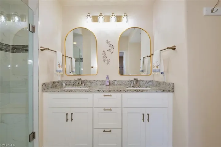 Bathroom featuring walk in shower and vanity