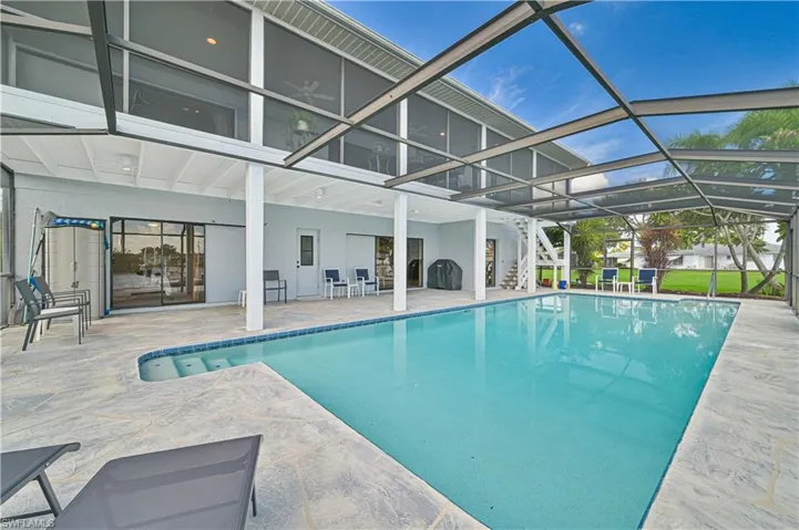 View of pool with a lanai and a patio area