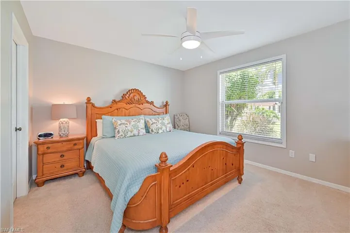Carpeted bedroom with ceiling fan