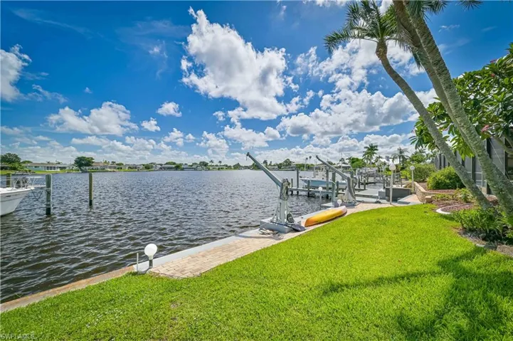 Dock area featuring a water view and a yard