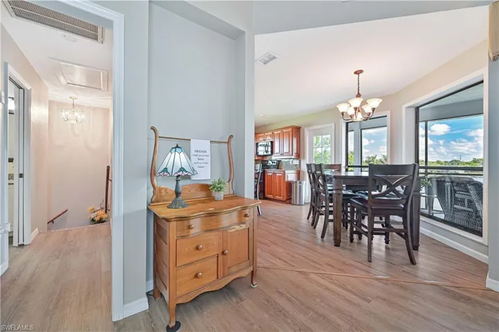 Dining room featuring light wood-type flooring and a chandelier