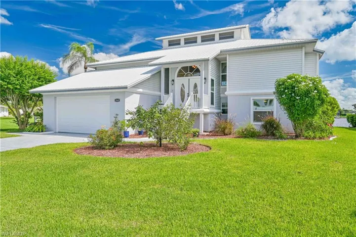View of front facade with a front yard and a garage