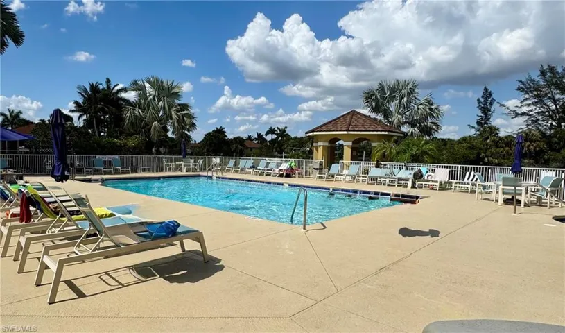 Community pool with fence and a patio