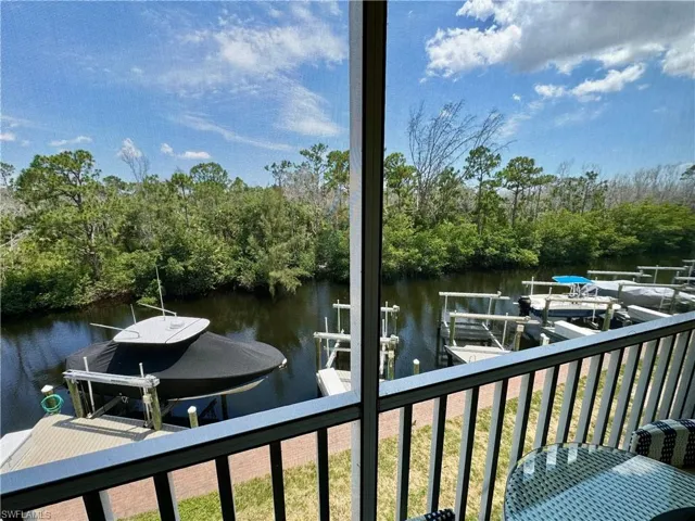 Dock area with a water view and boat lift