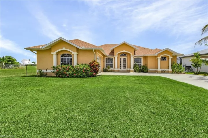 Single story home with lush lawn and landscaping.