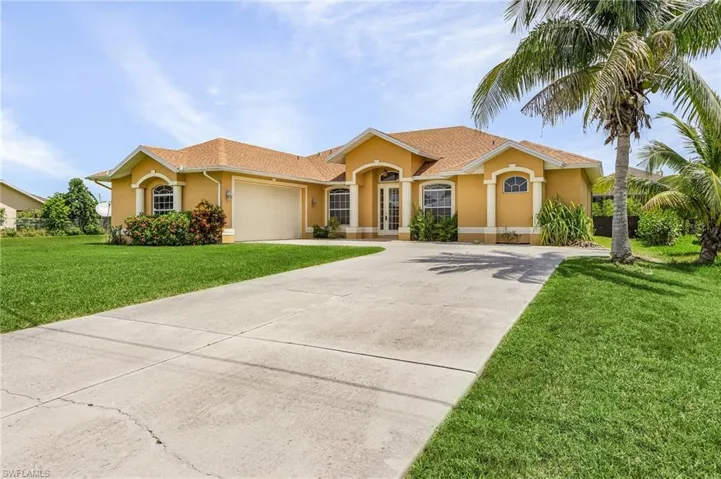 View of front of property with a side loading double car garage.