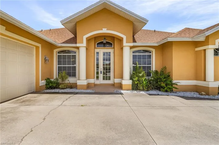 Entrance with high rooflines and french doors.
