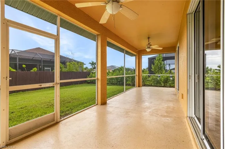 Rear screened lanai with two ceiling fans.