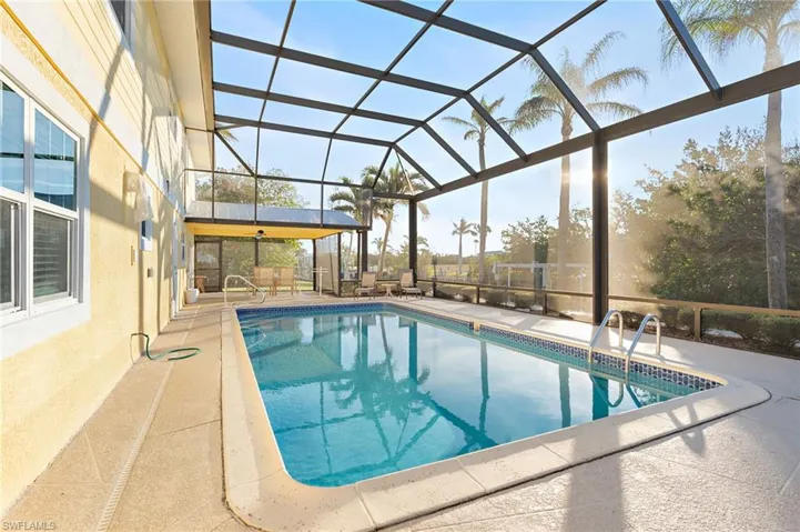 View of swimming pool with a lanai and a patio area