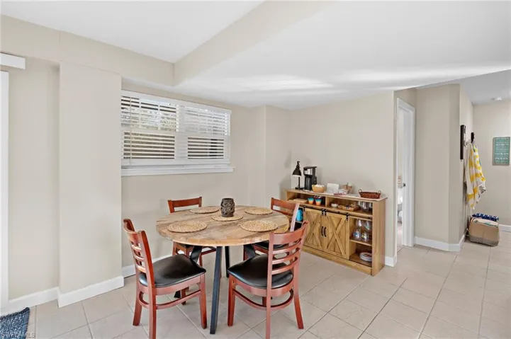 Dining space with light tile patterned floors