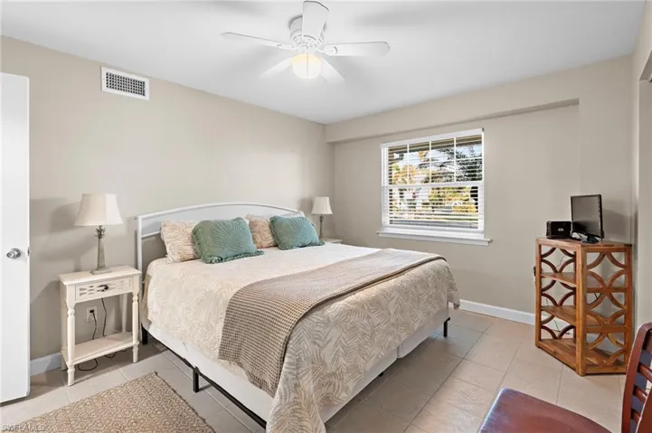 Tiled bedroom with ceiling fan