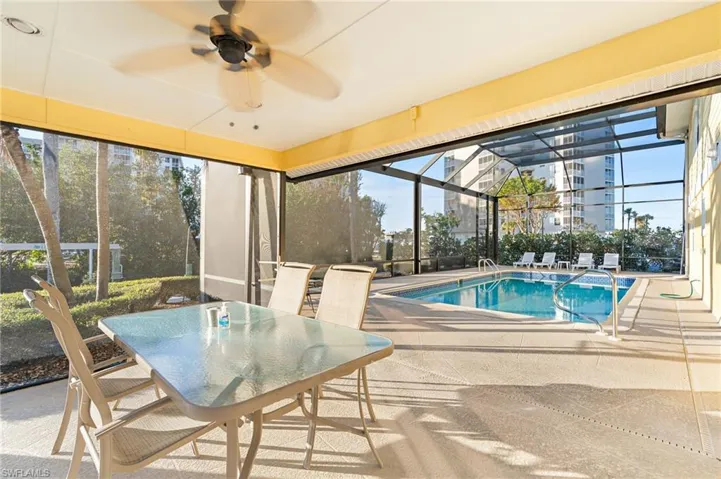 View of pool featuring ceiling fan