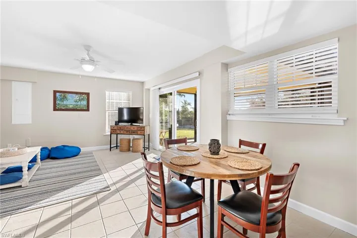 Tiled dining room featuring ceiling fan