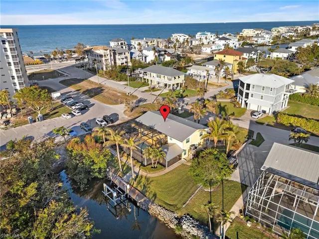 Birds eye view of property with a water view