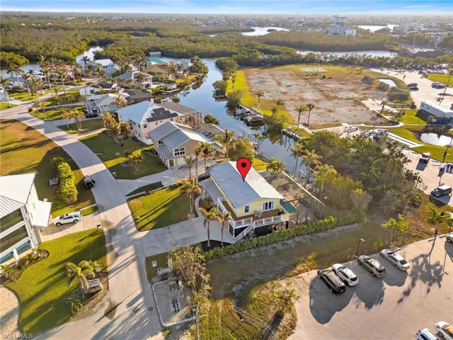Birds eye view of property with a water view