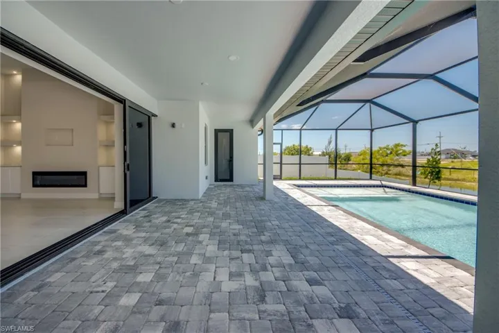 Outdoor pool featuring a lanai and a patio area