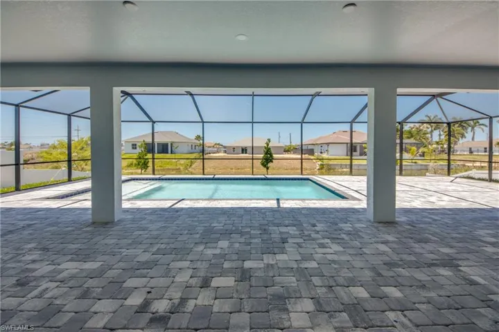 Outdoor pool featuring a residential view, a lanai, and a patio area