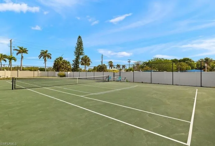 View of tennis court featuring community basketball court