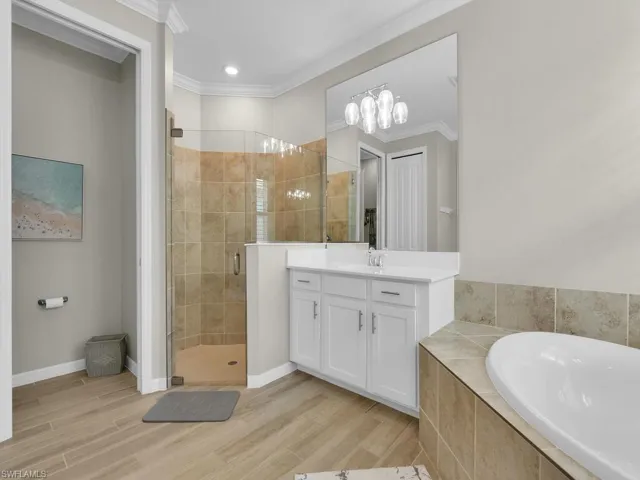 Owner’s bath featuring a large walk-in shower with a sleek glass enclosure.