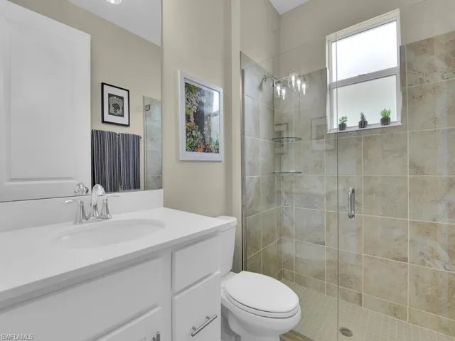 Guest bath boasts a generous shower with a stylish glass enclosure
