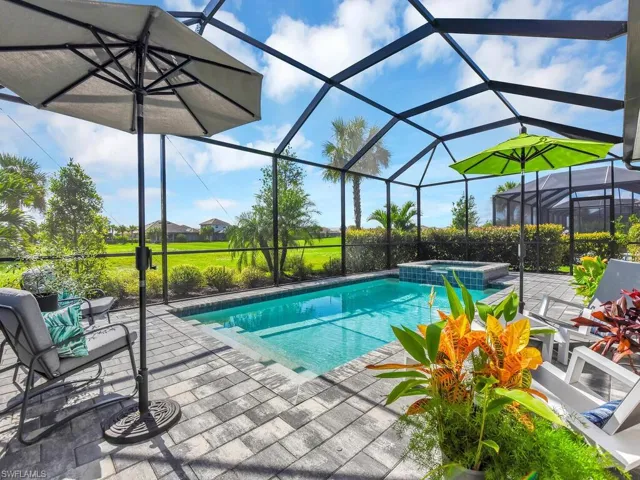 Outdoor oasis with a saltwater pool and lanai, perfectly positioned on the #11 fairway of a Gordon Lewis-designed course