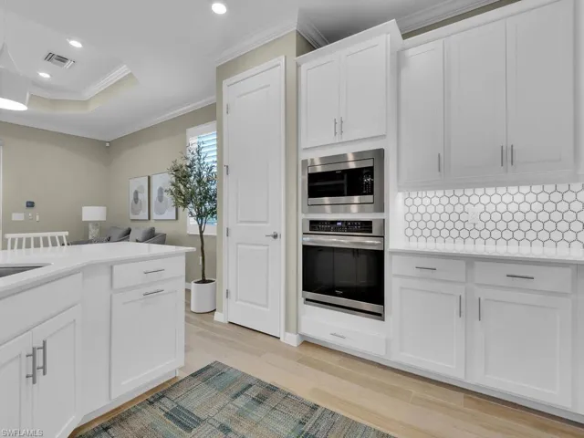 Modern kitchen with a wall oven and spacious pantry for convenience