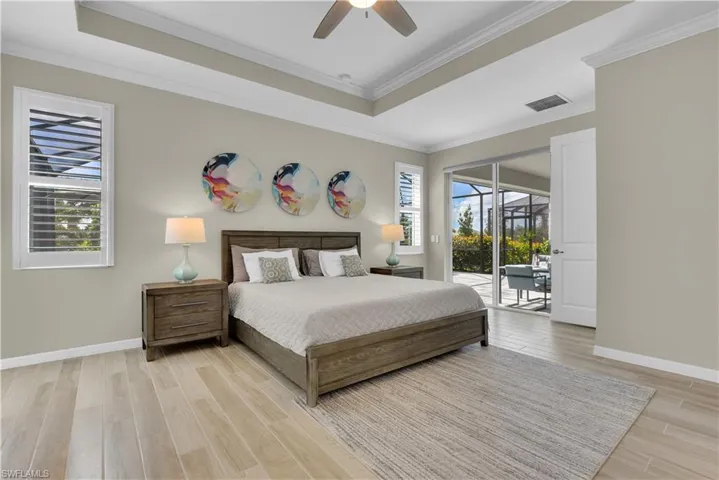 Owners retreat featuring a slider to the lanai and pool area