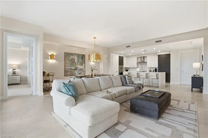 Living room featuring a chandelier, recessed lighting, and light tile patterned flooring