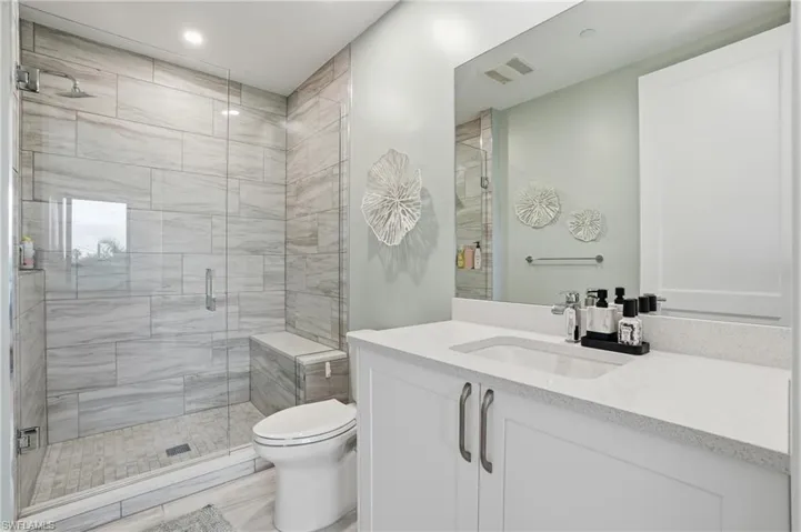 Full bathroom featuring a stall shower and vanity