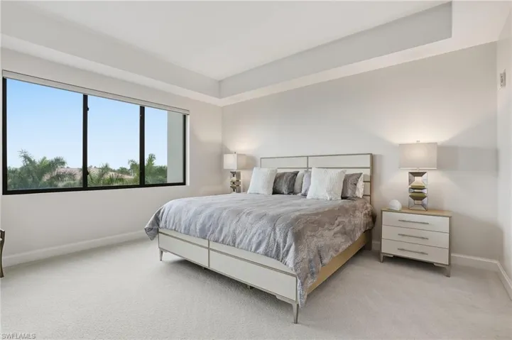 Carpeted bedroom featuring baseboards
