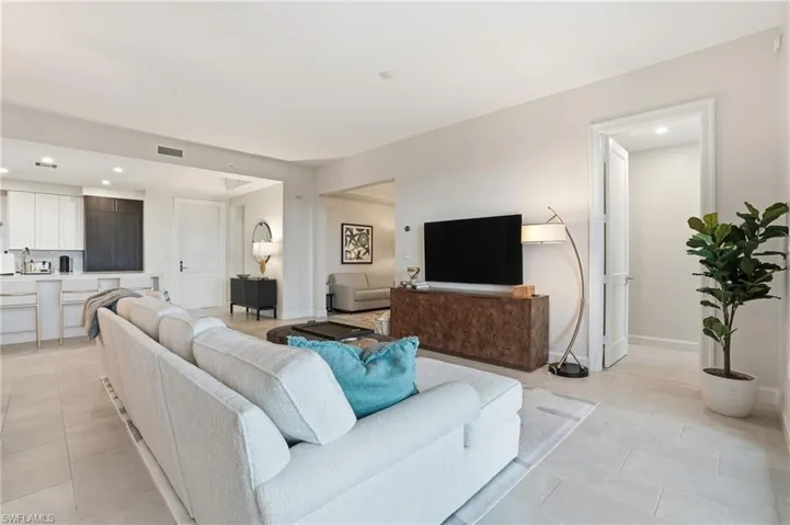 Living area with recessed lighting and light tile patterned floors