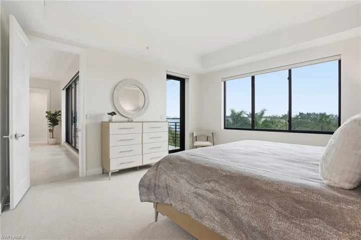 Bedroom with access to outside and light colored carpet