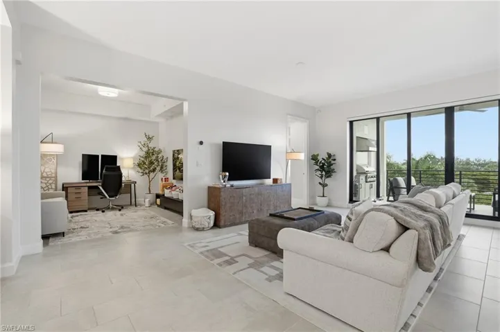 Living room with a desk and light tile patterned floors