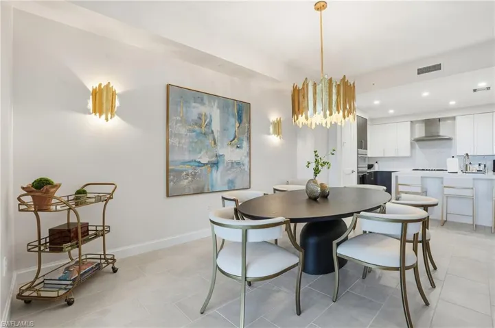 Dining area featuring recessed lighting, a chandelier, and light tile patterned flooring