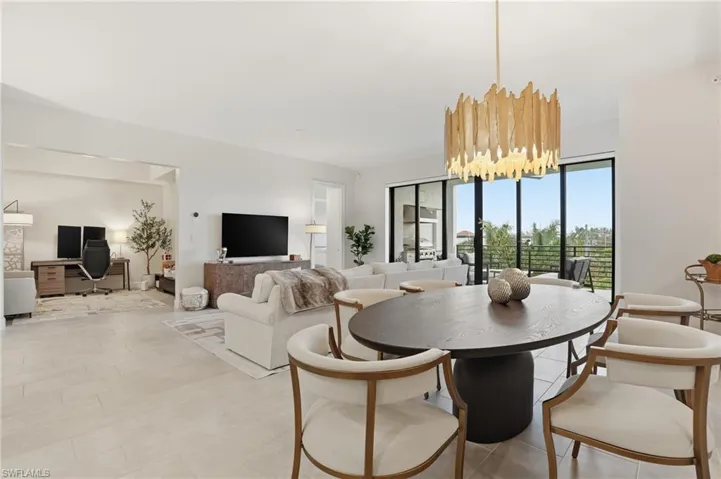 Dining room with a desk and a chandelier