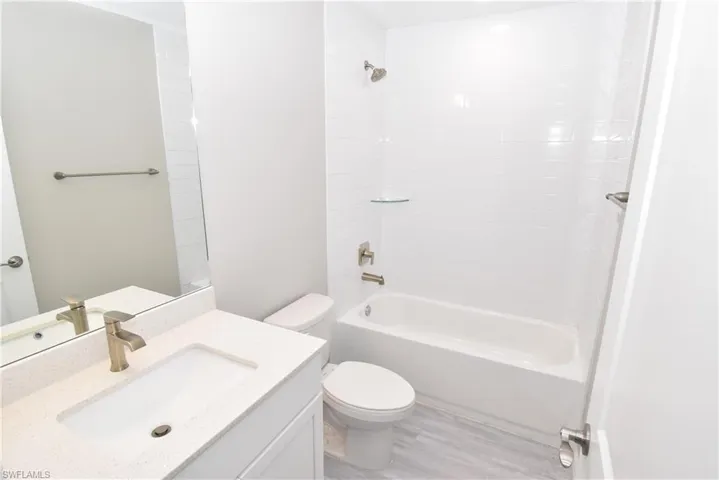 Full bathroom featuring vanity, bathtub / shower combination, and light wood-type flooring