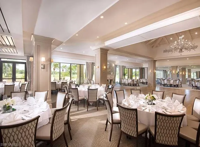 Dining area featuring ornate columns, a chandelier, and recessed lighting